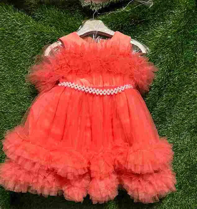 Orange/coral sleeveless tulle gown with ruffled flower neckline and pearl waistband