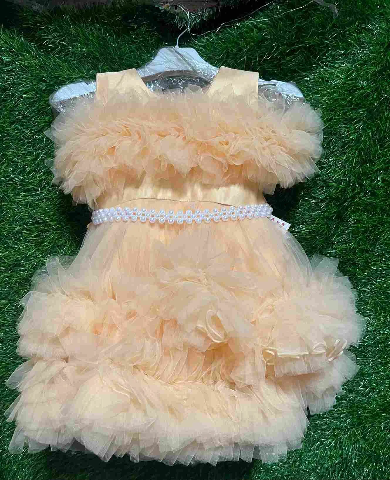 Peach/cream fluffy tulle gown with pearl waistband and bow details