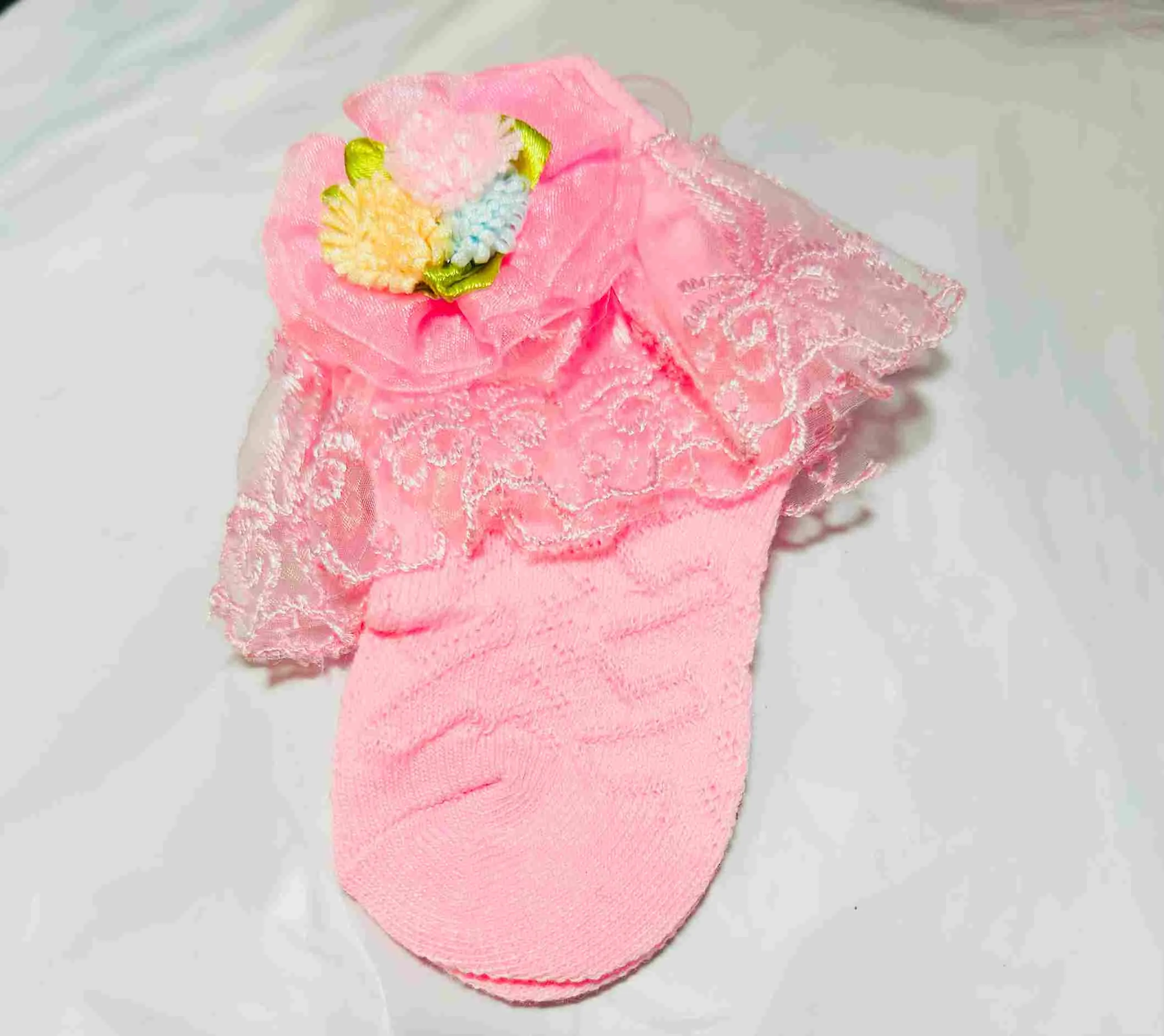 Pink lace ruffle sock with flower detail
